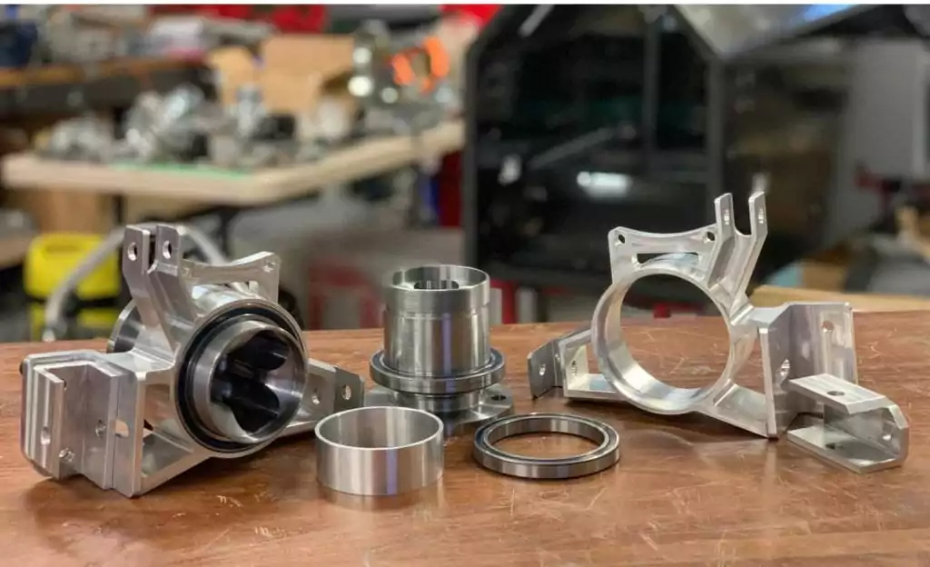 CNC Machined Parts with Imperial Racing Green and Hong Kong Machining Services Inc. Logos